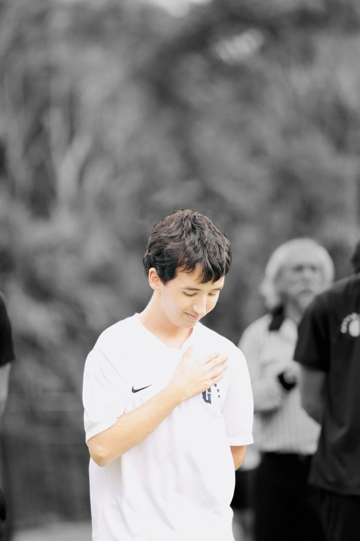 Max Taylor in a white Gulliver jersey, hand over his heart