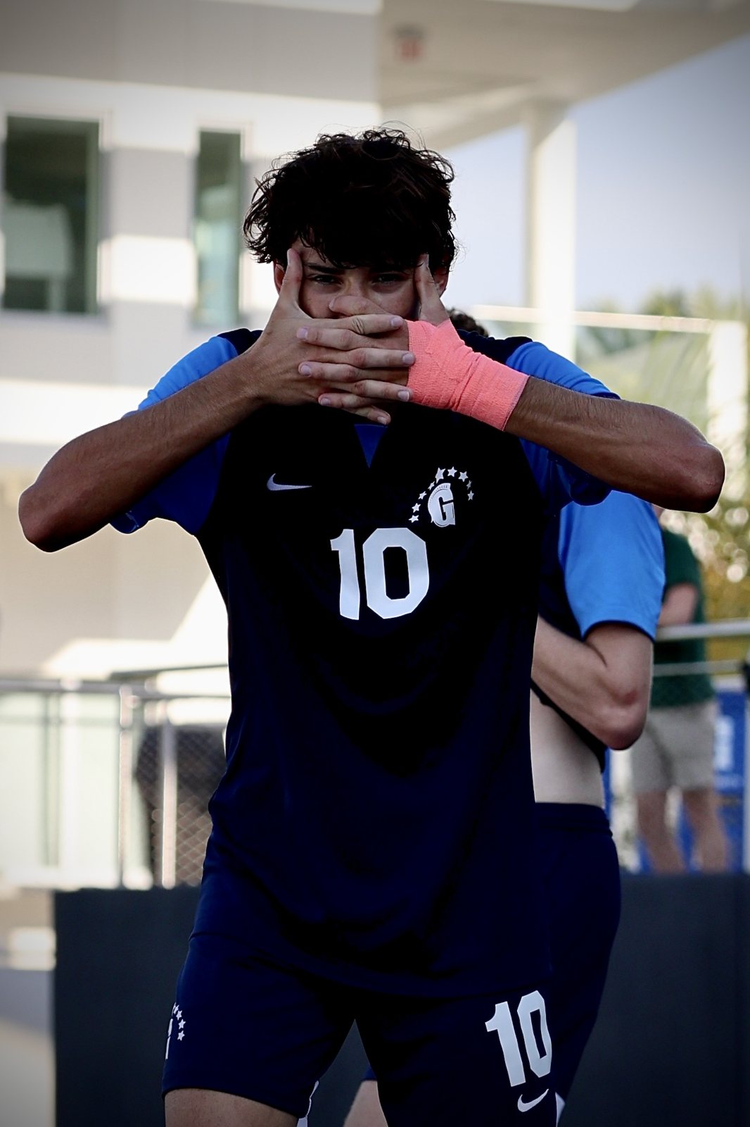 Gulliver No. 10 covering his face with both hands in celebration